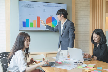 Asian business team meeting present professional investor working with new startup project. discussion and analysis data the charts and graphs. Digital tablet laptop computer design smart phone