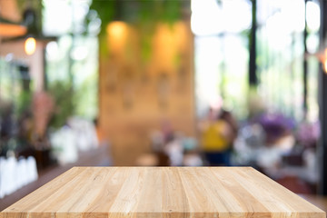 Empty wooden table and blurred cafe background, can be used for display or montage your products