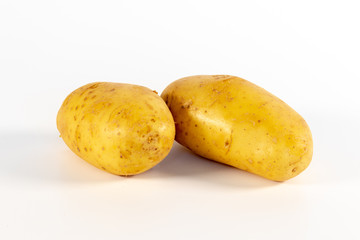 Two unpeeled fresh potatoes isolated on white background