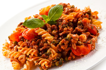 Pasta with tomato sauce on white background