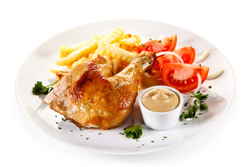 Roast chicken leg with french fries on white background
