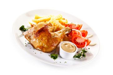 Roast chicken leg with french fries on white background