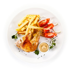 Roast chicken leg with french fries on white background