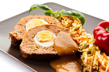 Meatballs stuffed with boiled eggs with vegetables