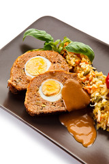 Meatballs stuffed with boiled eggs with vegetables