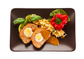 Meatballs stuffed with boiled eggs with vegetables