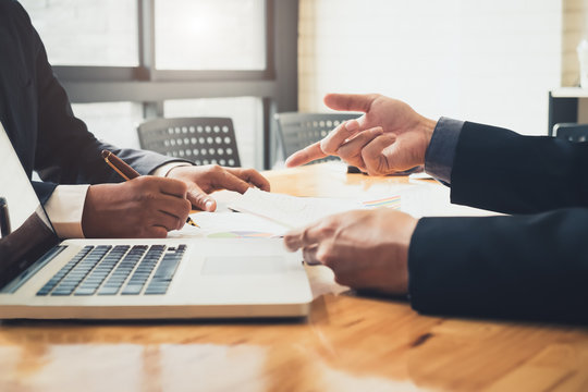 Asian business adviser meeting to analyze and discuss the situation on the financial report in the meeting room.Investment Consultant,Financial Consultant,Financial advisor and accounting concept