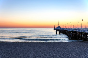 Sopot wooden pier (molo), beach and Baltic Sea at dawn, Poland - obrazy, fototapety, plakaty