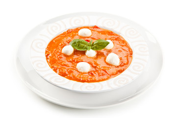 Tomato soup with mozzarella on white background