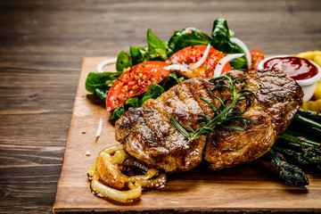 Grilled steak with french fries and vegetables