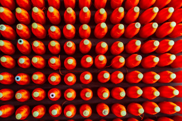 Top View Group of Silk Spools with Red Silk Thread Yarn for Weaving Machine to make Thai Fabric Silk
