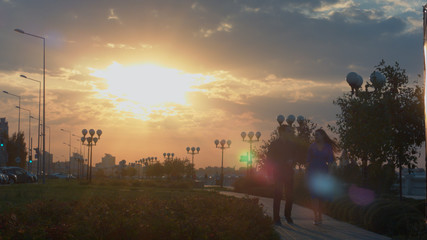 Young couple walk during sunset.
