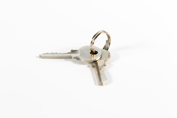 Wad of keys with two small keys isolated on white background
