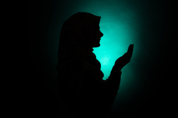 silhouette of muslim woman praying