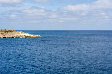 Photo of Mediterranean Sea, view from Valletta, Malta. Blue cloudy sky as background.