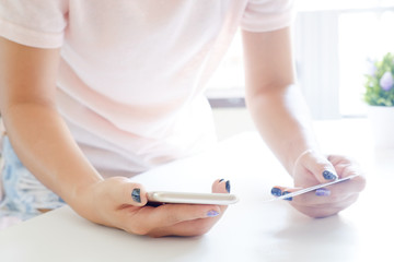 Female shopping online with mobile smartphone.