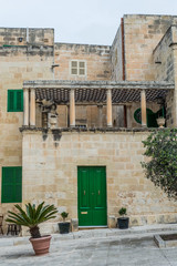 Fototapeta na wymiar Photo of Typical street of Malta, ancient buildings and architecture