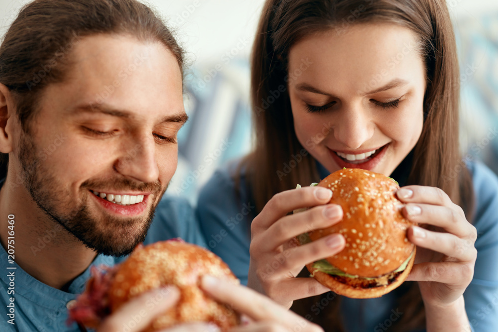 Wall mural friends eating burgers indoors