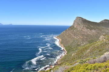 Fototapeta na wymiar Beautiful nature with the blue raw ocean on the way to the Cape of Good Hope in Cape Town on the Cape Peninsula Tour in South Africa