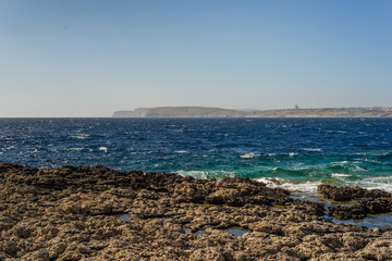Fototapeta na wymiar Photo of Sea water beating against rock, Cirkewwa, Malta