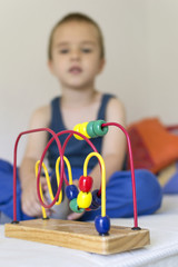 Educational toy for kids with cute boy in background. Selective focus.