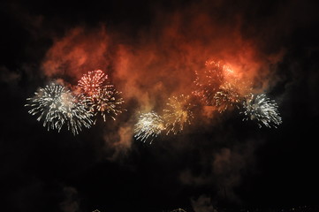 Colorful fireworks night. Holiday festival at the coast. Summer national celebration with the colourful sparks in the sky above the sea.