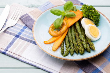 Fried asparagus with broccoli and lemon and carrot.