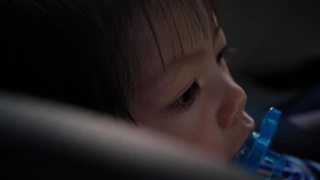 baby sucking nipple pacifier on car seat safe drive