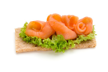 Bread with fresh salmon fillet isolated on white background, top view.