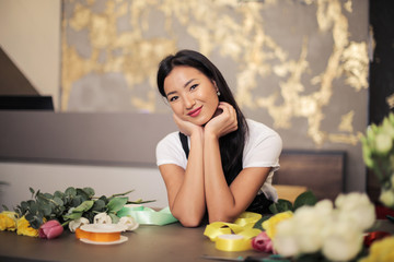 Cheerful florist at the counter