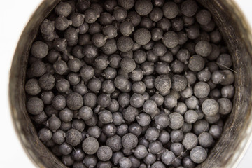 gray metal shot in tin on white background