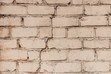 powder pink brick wall with a crack, close-up