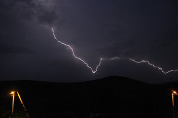 Dark picture of powerful lightning in the night sky. Rainy autumn day