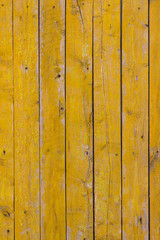 Obraz premium wooden fence painted yellow, close-up