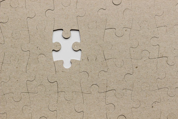 gray crafting puzzle with one missing piece on white background, crafting background, close-up