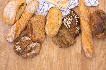 Various kinds of delicious brown breads are ready to be served to customers in bakery shop.