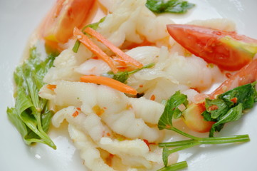 spicy chicken foot with chili and lime salad on white plate