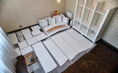 Unpacked elements of a new cabinet ready for assembly