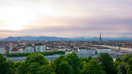 Fototapeta na wymiar Turin skyline at sunset. Torino, Italy, panorama cityscape with the Mole Antonelliana over the city. Scenic colorful light and dramatic sky.