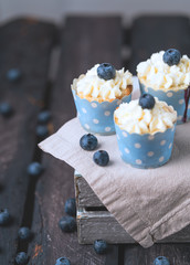 Cupcakes blueberries, wooden box, linen cloth, rustic style, vintage effect, foggy effect, blue color cupcake papper,