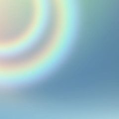 a strip of a rainbow on a cloudy sky