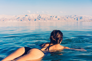 Girl is relaxing and swimming in the water