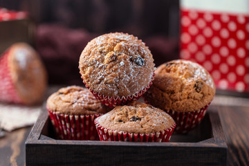 Fresh homemade delicious muffins with raisins on rustic background.  