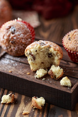 Fresh homemade delicious muffins with raisins on rustic background.  