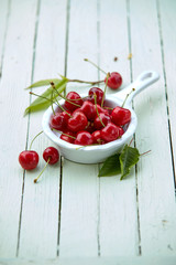 Small ceramic pannikin with fresh ripe cherries