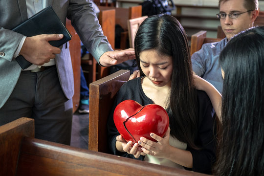 Believers Praying For Young Sad Beautiful Girl with Her Broken Heart, Concept Picture of Love and Caring for Each Other.