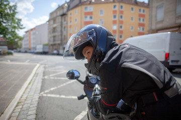 Woman with a black helmet on a motorbike