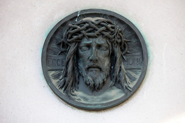 Ecce homo, Dead Christ - bronze medallion on Mirogoj cemetery in Zagreb, Croatia