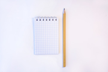 Cute notepad with pencil on the white background
