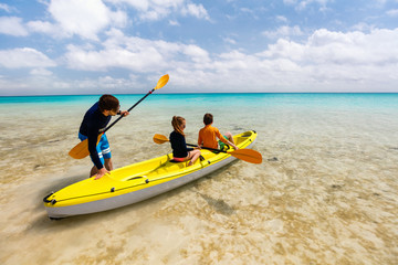 Family kayaking at tropical ocean